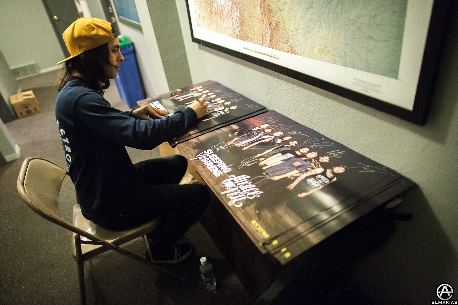 Vic Fuentes of Pierce The Veil signing posters